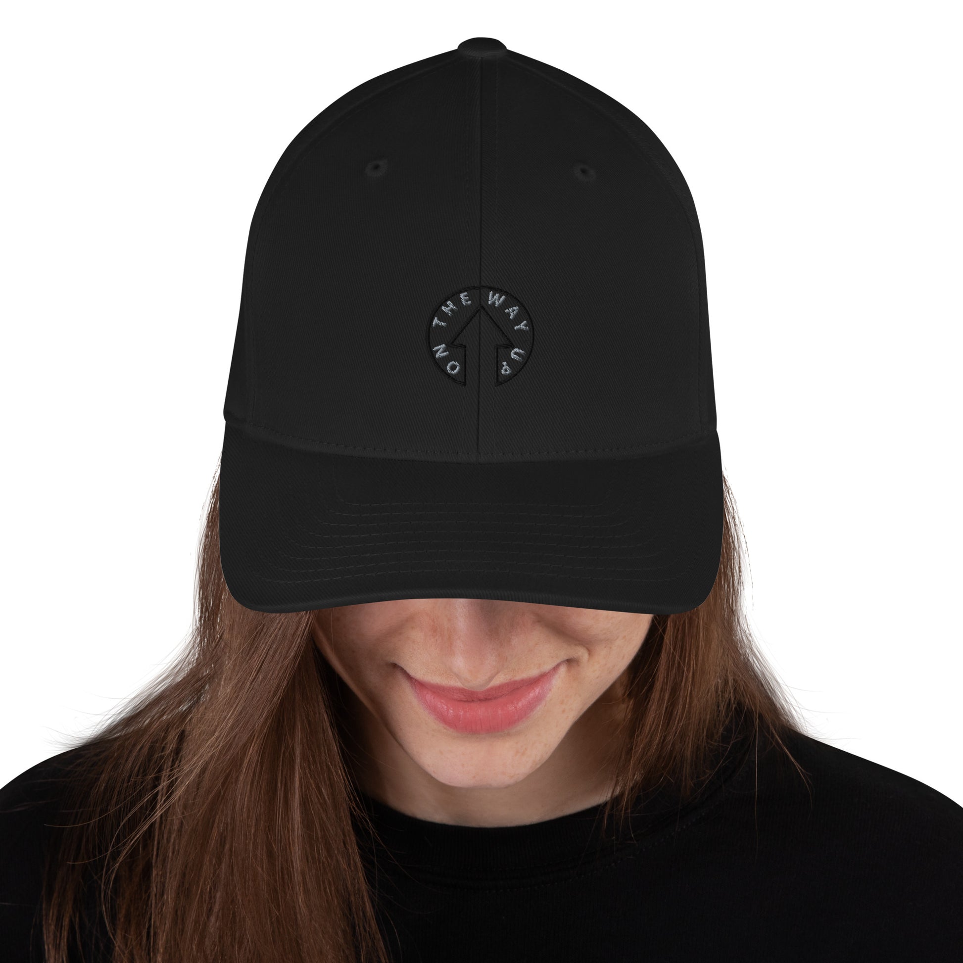 A smiling woman with long brown hair wearing an On The Way Up Apparel Stretch Fit Signature Cap that has a circular white logo with the text "Premium Quality" on the front. Only her face and upper torso are visible.