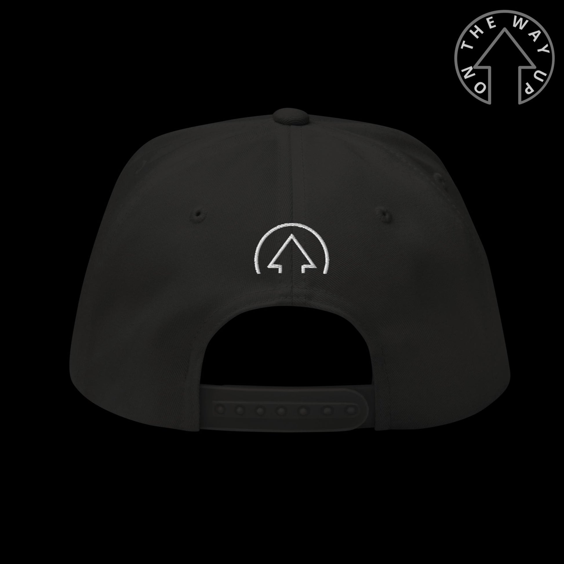 A black baseball cap with a white "On The Way Up" logo embroidered on the front, displayed against a dark background. The On The Way Up - Progress Snap Back cap has an adjustable strap visible at the back.