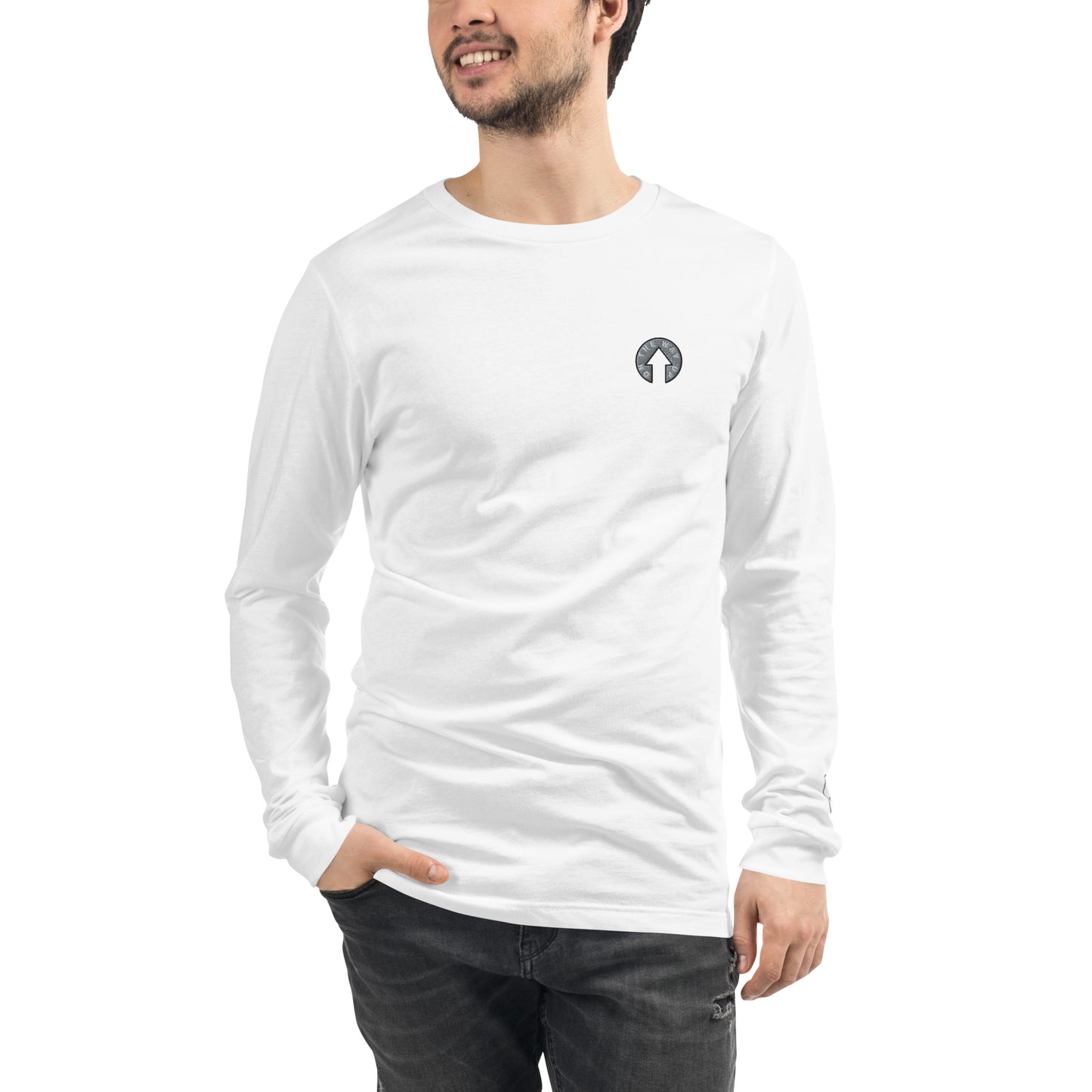 A man wearing an On The Way Up Apparel On The Way Up Signature Embroidered Logo Long Sleeve Tee White, standing with one hand on his hip, against a white background.