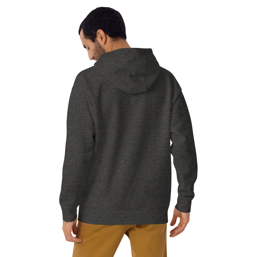 A man viewed from behind, wearing an On The Way Up Progress Hoodie - Charcoal and mustard trousers, standing against a plain black background, exudes premium quality.