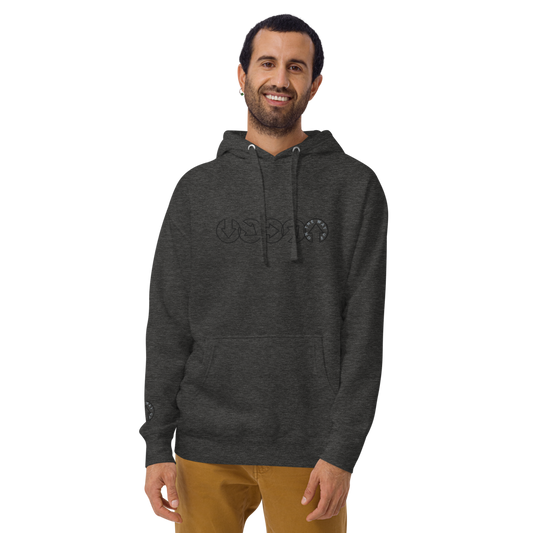 A smiling man in an On The Way Up Apparel gray hoodie with a "Premium Quality" cursive logo and khaki pants stands against a plain background. He has short dark hair and a well-groomed beard.