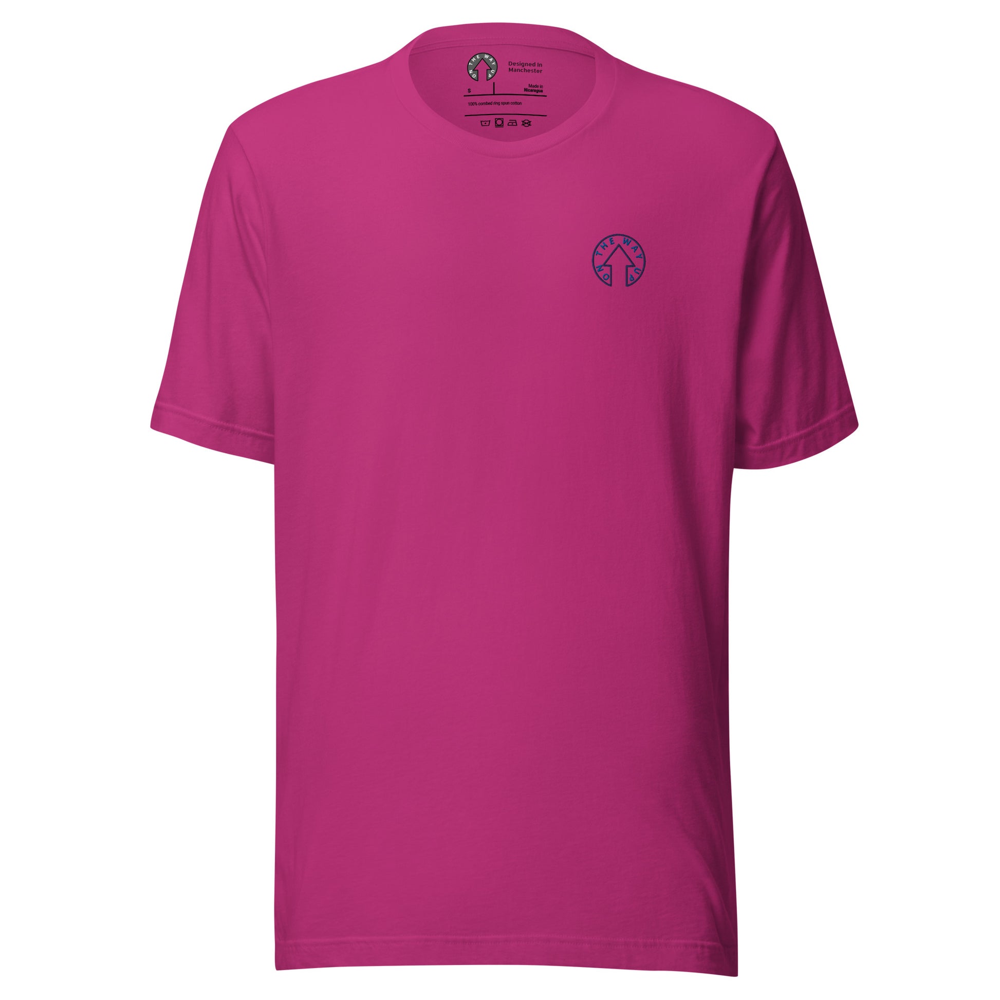 A bright fuchsia pink BE BOLD - On The Way Up Embroidered Logo t-shirt displayed against a white background, featuring a small "Manchester" logo on the left chest area. The shirt has a crew neckline and short sleeves.