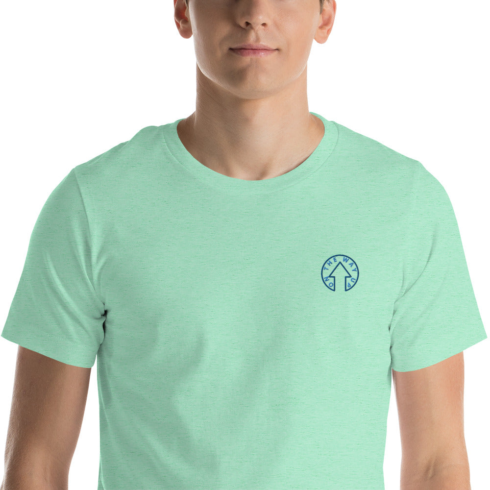 A young man wearing a BE BOLD - On The Way Up Embroidered Logo T-shirt in Mint Green by On The Way Up Apparel, with the logo on the left chest area. He is facing forward with a neutral expression.