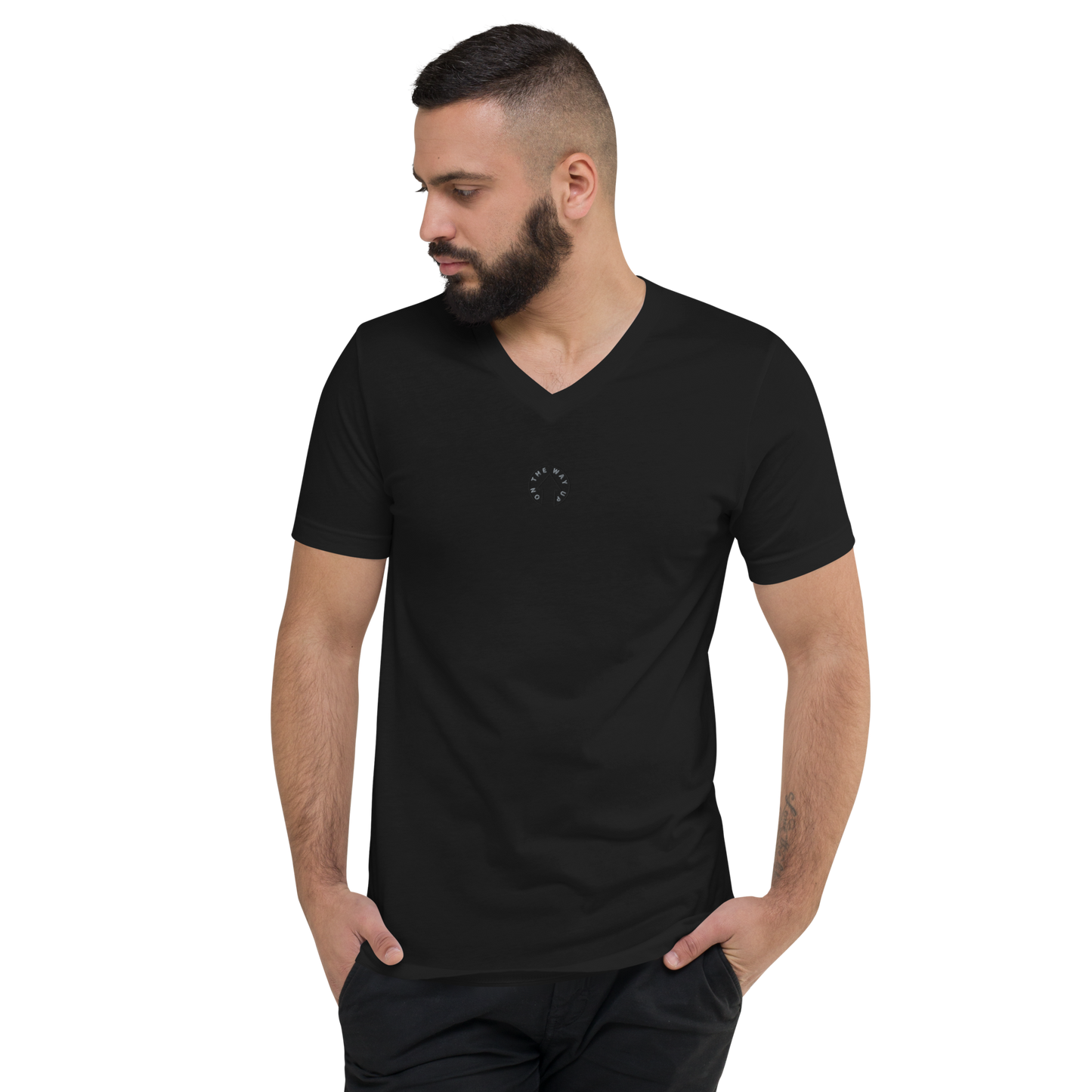 A man with a beard wearing an On The Way Up Apparel Signature Short Sleeve V-Neck T-Shirt in black, looking to his left, on a black background.