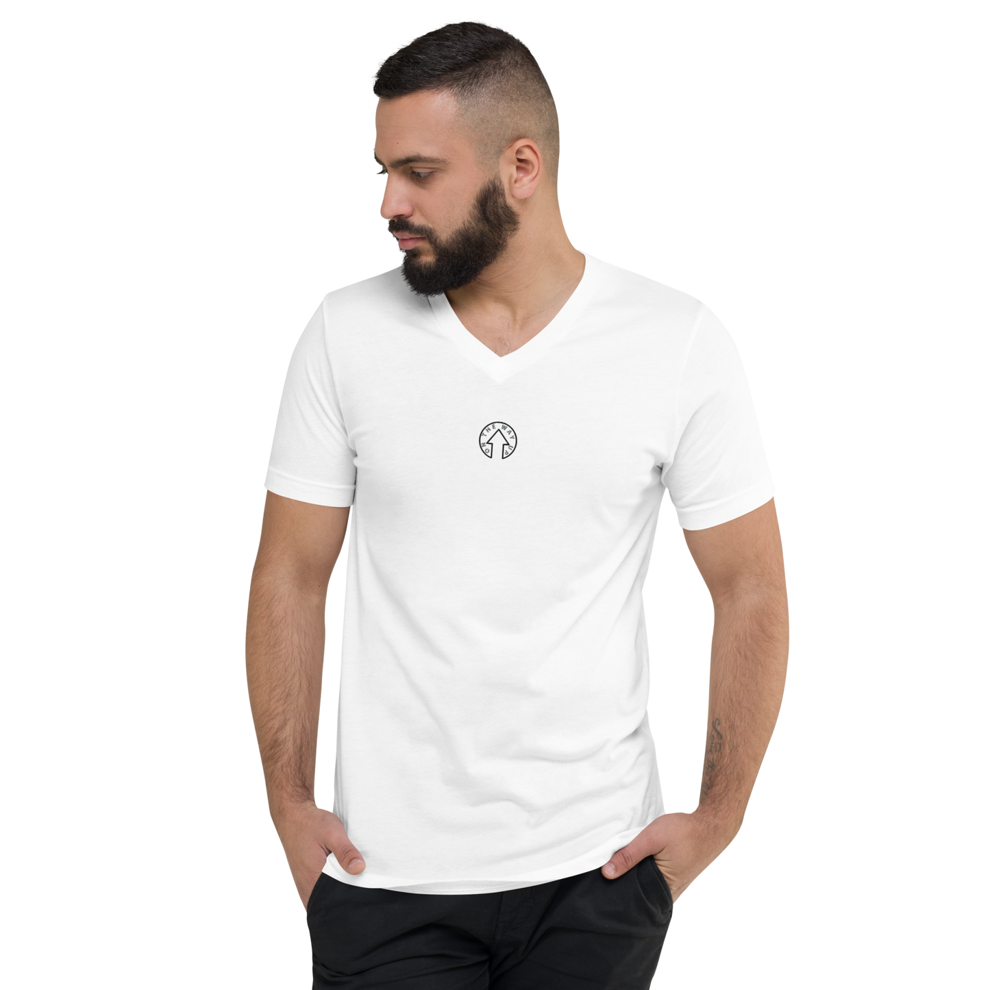 A man with a beard wearing an On The Way Up Apparel Signature Short Sleeve V-Neck T-Shirt with a small logo on the chest, looking to the side against a black background.